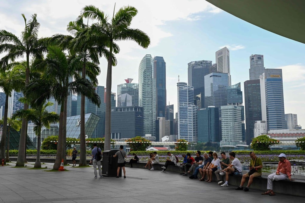 People rest next to ArtScience museum at the Marina Bay Sands in Singapore. Photo: AFP