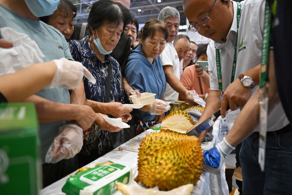 Visitors wait to taste local durians during the 26th China (Hainan) International Tropical Agricultural Products Winter Trade Fair in Haikou, Hainan province, in December 2023. The advent of Chinese-grown durians was one of the food stories of the year in Asia, and the Post gave one a taste test. Photo: Xinhua
