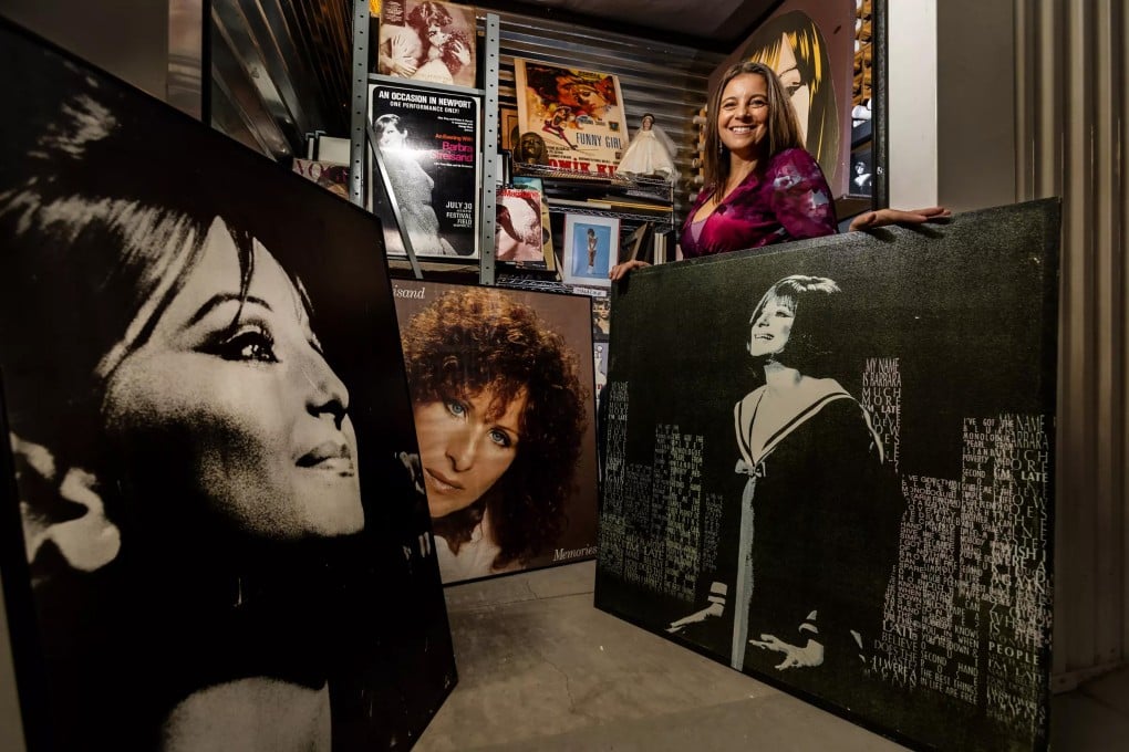 Mara Papalas stands amid Barbra Streisand memorabilia that makes up part of her late father’s vast collection, which she is hoping someone will buy. She has no personal interest in the items, and keeping them in storage costs money. Photo: Los Angeles Times/TNS