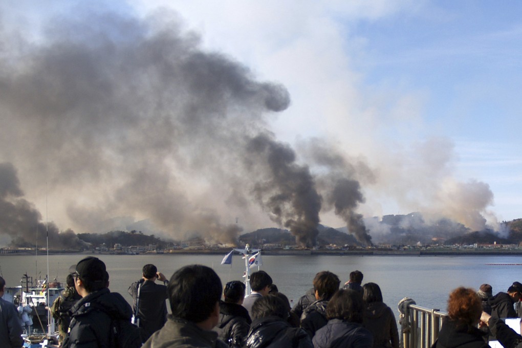 South Korean villagers watch smoke rise from Yeonpyeong Island following shelling in 2010 that killed four civilians. A former North Korean spy chief accused of orchestrating the attack was recently rehabilitated by Pyongyang. Photo: Yonhap via AP