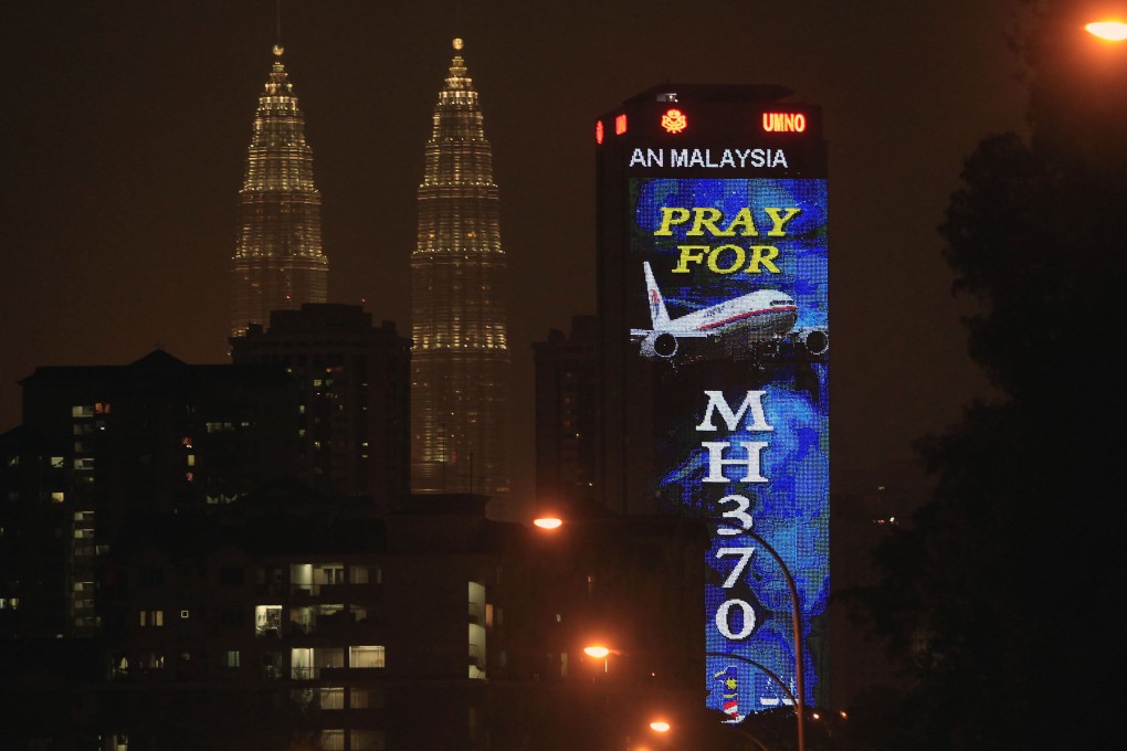 An office building in Kuala Lumpur is illuminated with LED lights displaying “Pray for MH370” next to Malaysia’s landmark Petronas Twin Towers in 2014. A Singapore-raised comedian’s joke about the missing flight enraged Malaysia this year. Photo: AP