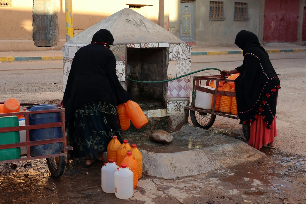 Moroccan women fill up containers with water from a hose, in Zagora, southeastern Morocco. Activists are demanding equality in inheritance, child custody, and a total ban on child marriage – none of which they say are guaranteed under the current family code. Photo: AP