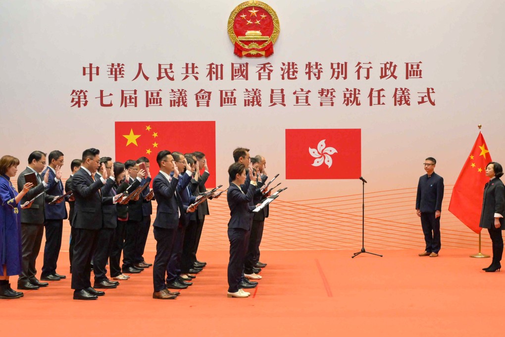 District councillors swear an oath of allegiance under the supervision of Secretary for Home and Youth Affairs Alice Mak (right). Photo: Handout.