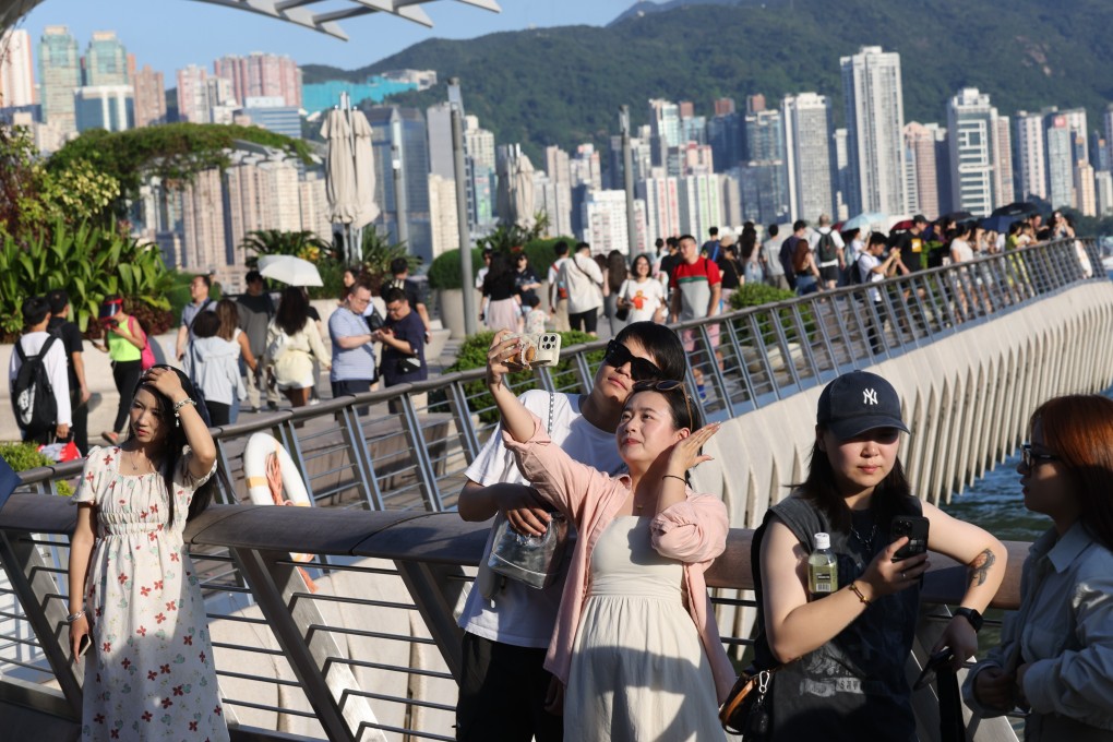 Mainland tourists visit Tsim Sha Tsui on September 28. Hong Kong dropping the last of its Covid-19 pandemic restrictions and removing the mask mandate were significant steps in returning a sense of normality to the city. Photo: Yik Yeung-man