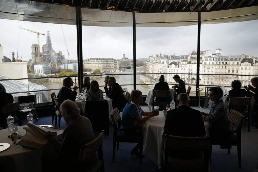 Customers at Paris Michelin-star restaurant the Tour d’Argent enjoy a meal with views of Notre Dame Cathedral. The restaurant, recently reopened after 18 months of renovations, will offer prime views of the 2024 Summer Olympics opening ceremony in July. Photo: AP
