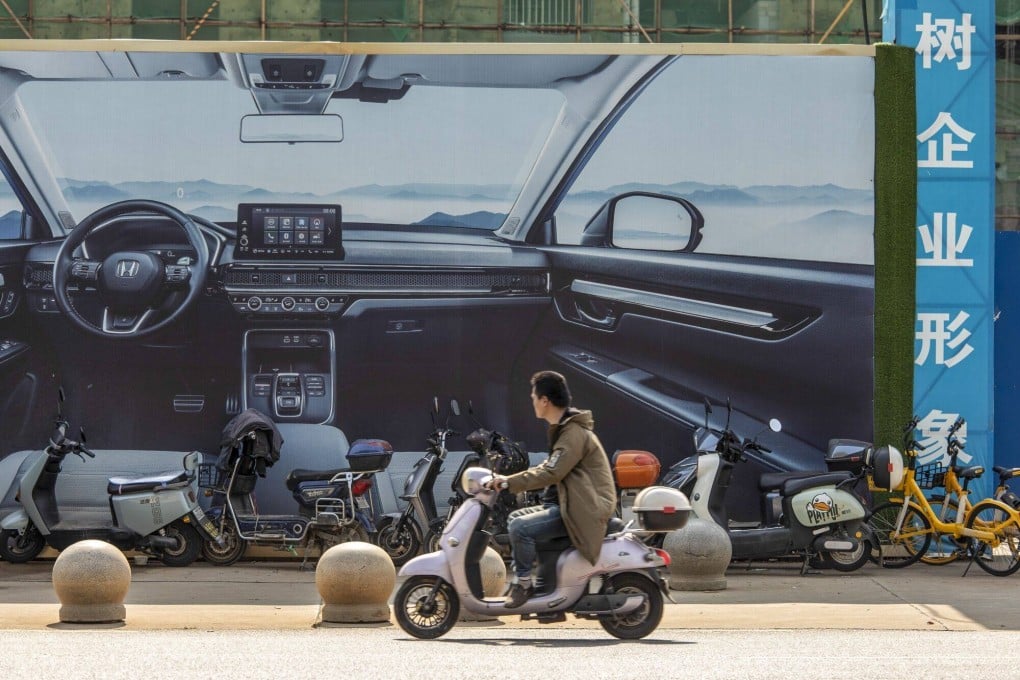 A billboard displays an ad for an electric vehicle in Wuhan. EV sales in China are likely to slow this year, piling pressure on weaker players. Photo: Bloomberg