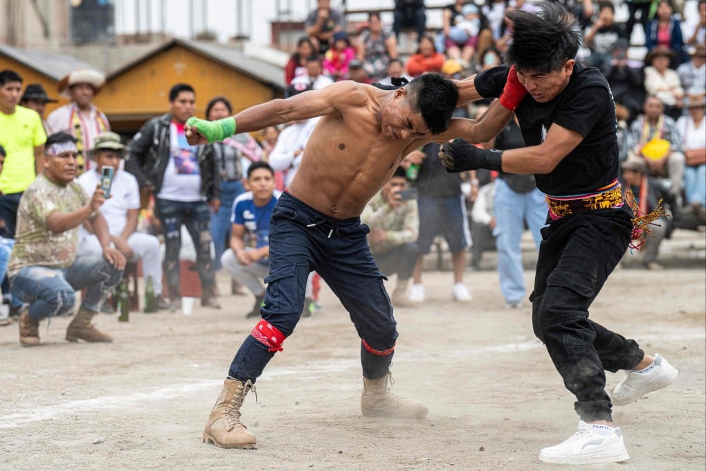 Inhabitants of the province of Chumbivilcas, in Cuzco, southern Peru, celebrate Takanakuy in San Juan de Lurigancho, on the outskirts of Lima, on December 25, 2023. Takanakuy is an annually established practice of duelling fights between community members that combines music, traditional dances, and Christian symbols. Photo: AFP