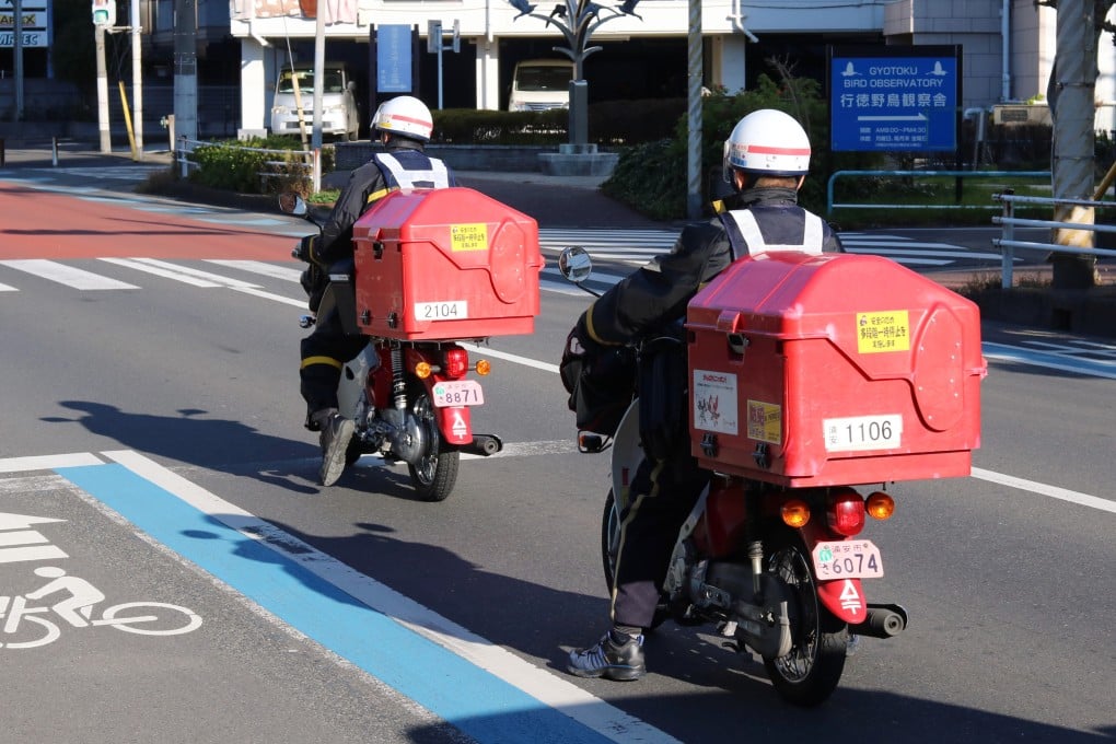 Post office workers on motorcycles deliver New Year cards on New Year’s Day in Ichikawa City, Japan in 2020. The number of cards delivered on the first day of 2024 declined nearly 16 per cent on the year. Photo: Shutterstock