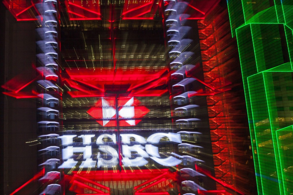 HSBC logo is seen lit up on the exterior of the HSBC headquarters building in Hong Kong’s financial district, Hong Kong, China. Photo: EPA