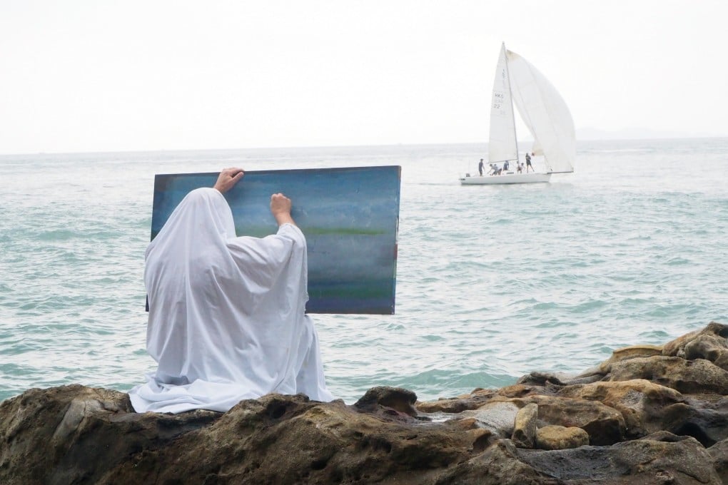 Belgium-based Spanish artist Angel Vergara paints a sea scene in Hong Kong while covered in his signature white cloth. Photo: Axel Vervoordt Gallery