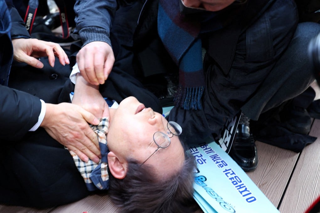 South Korean opposition party leader Lee Jae-myung falls after being attacked by an unidentified man during his visit to Busan on Tuesday. Photo: Yonhap via Reuters
