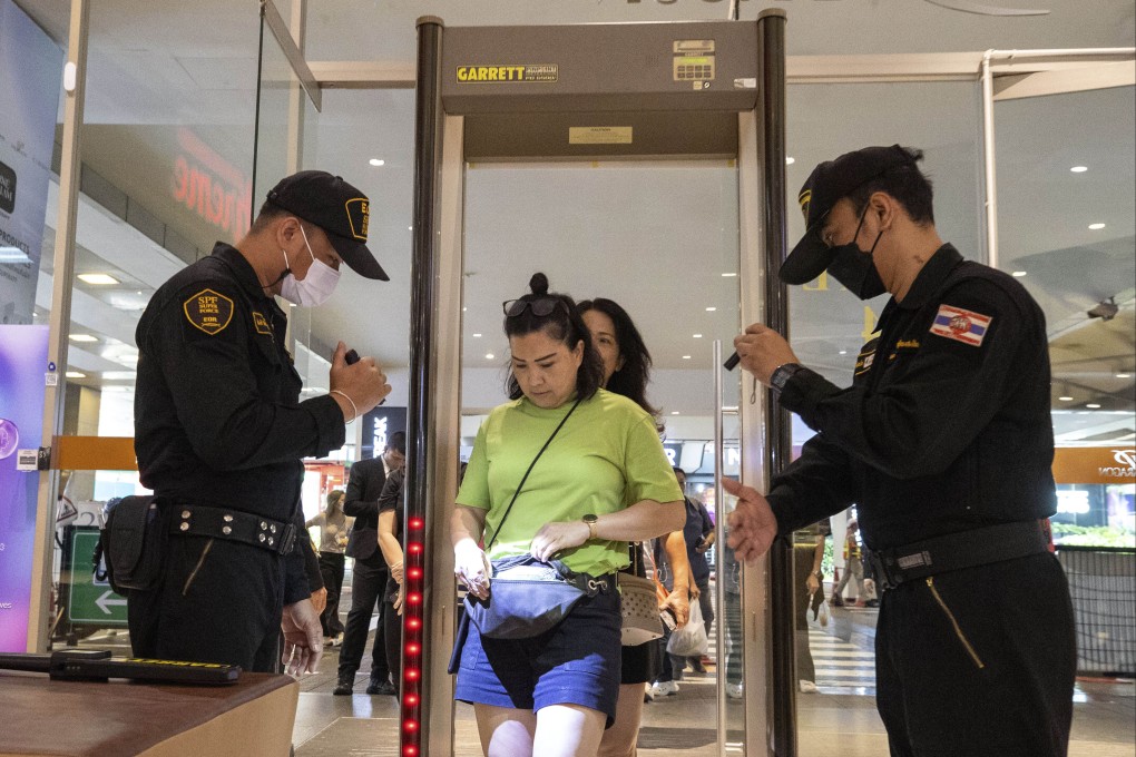 Security guards check visitors’ bag before allowing them into the Siam Paragon Mall in Bangkok. The October 3 shooting rampage at the Siam Paragon shopping centre left three dead and resulted in multiple injuries. Photo: AP