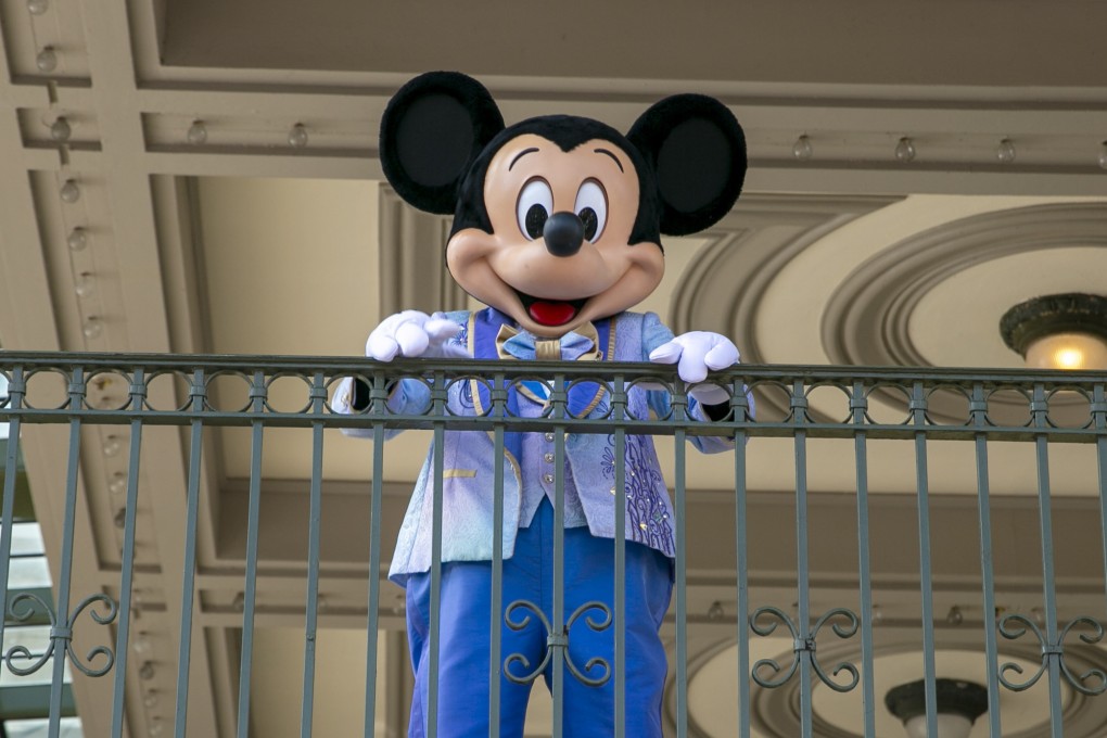 An actor dressed as Mickey Mouse greets visitors at the entrance to Magic Kingdom Park at Walt Disney World Resort in Florida. Photo: AP