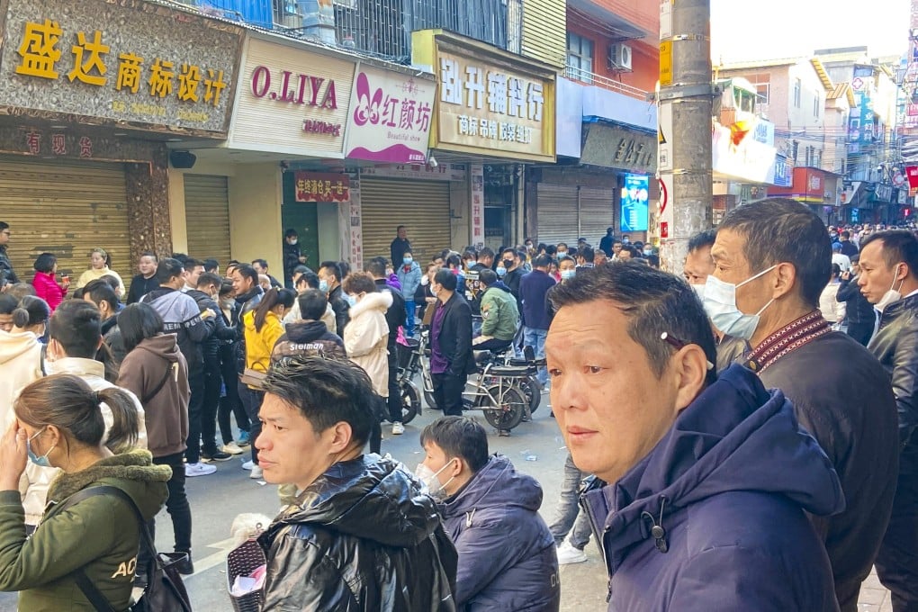 Migrant workers looking for work on Qiannan New Street, an open air job market in Guangzhou. Expanding urban registration for migrants could be a source of new consumption for an economy in need of heightened activity. Photo: Huifeng He