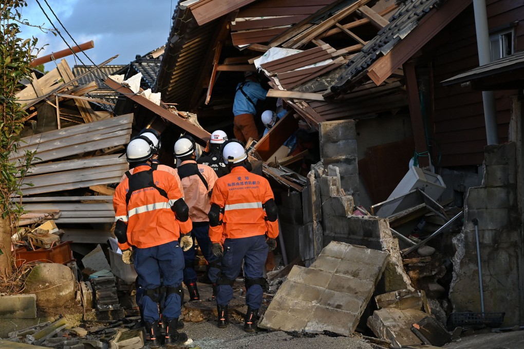 Firefighters inspect collapsed wooden houses in Wajima, Ishikawa prefecture, Japan on Tuesday. Photo: AFP / Getty Images / TNS