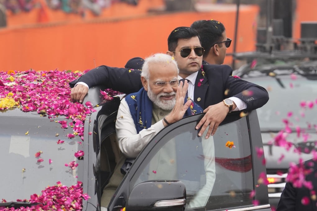 Indian Prime Minister Narendra Modi waves to crowds before inaugurating a new airport and railway station in Ayodhya on Saturday. A new Hindu temple on a disputed site in the city will be opened on January 22. Photo: AP