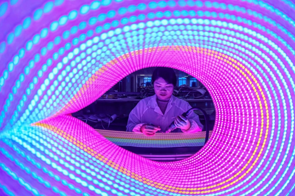 A worker checks LED lights for export at a factory in Ruichang, in central China’s Jiangxi province, on January 3. US and Chinese supply chains remain deeply intertwined, especially for “strategic products”. Photo: AFP