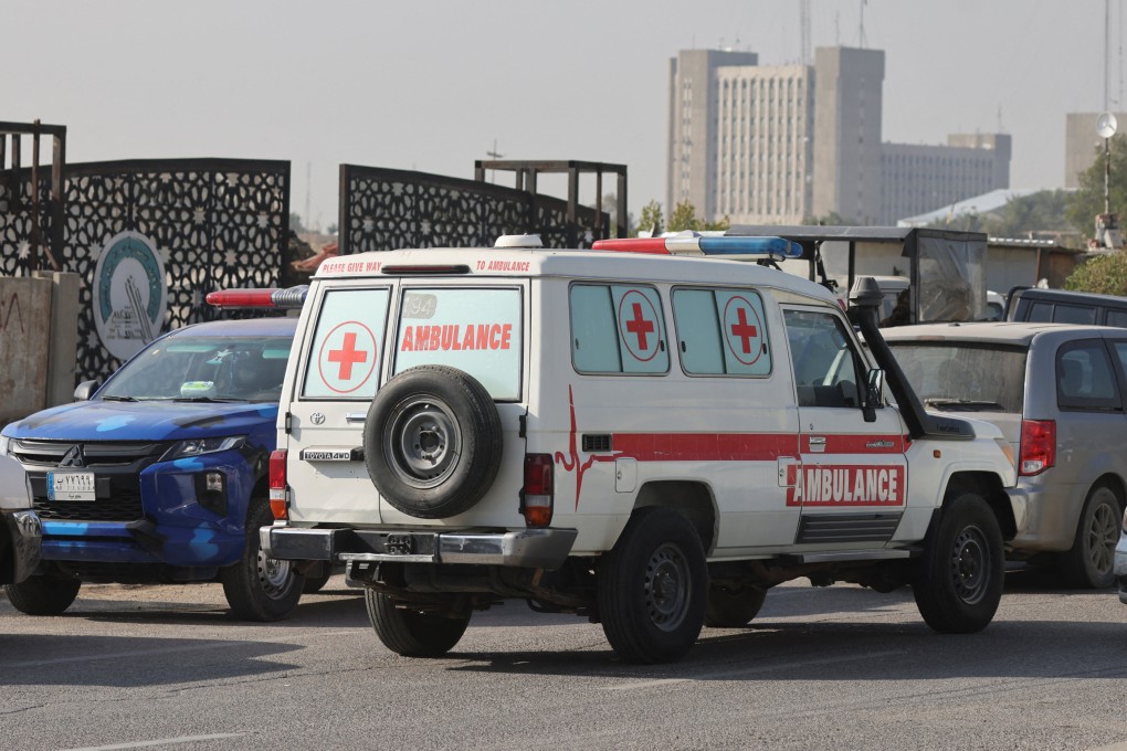 An Iraqi ambulance is parked next to a police vehicle at a street after an attack by a drone strike on an Iran-backed militia headquarters in Baghdad on Thursday. Photo: Reuters