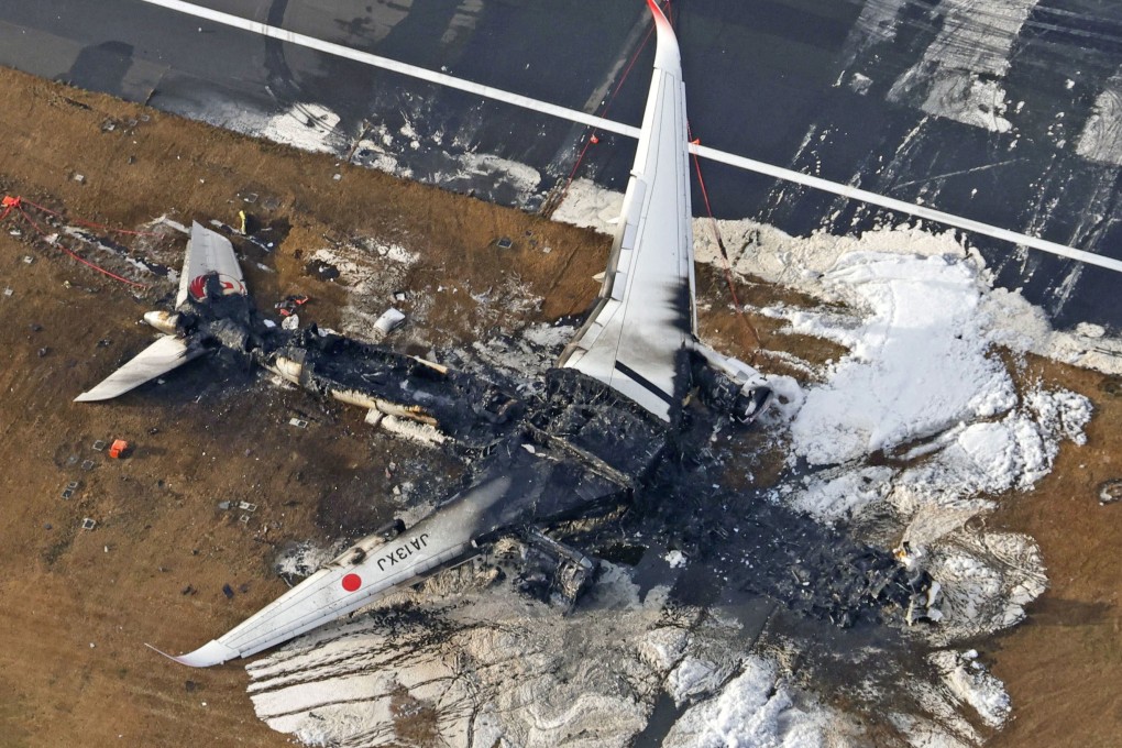 The burnt Japan Airlines plane after a collision with a coastguard aircraft at Haneda airport in Tokyo. Photo: Kyodo via Reuters