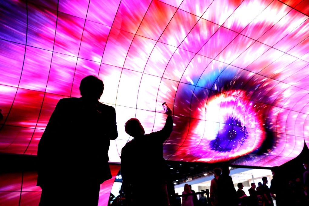 CES attendees watch an LG curved OLED screen at CES 2023. At this year’s event, AI is expected to take centre stage, with everything from glasses for the blind to shoes powered by the technology on show. Photo: Reuters