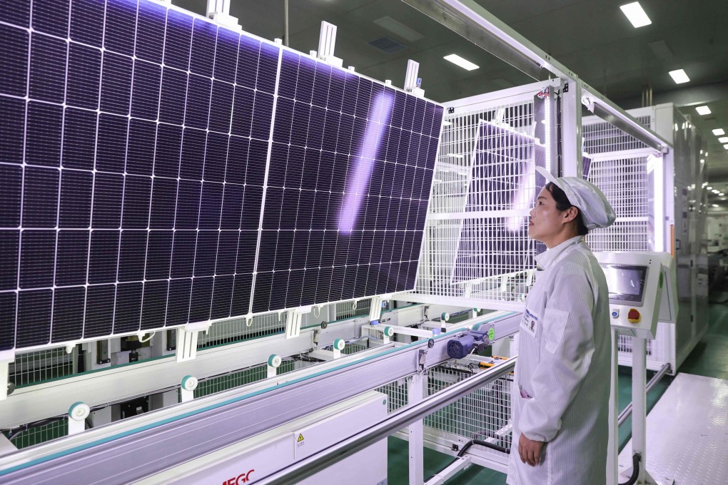 An employee works on solar photovoltaic modules that will be exported, at a factory in Lianyungang, Jiangsu province, on January 4.  China is investing heavily in the technologies, such as renewable energy, electric vehicles and AI, that will shape the global economy in the coming decades. Photo: AFP