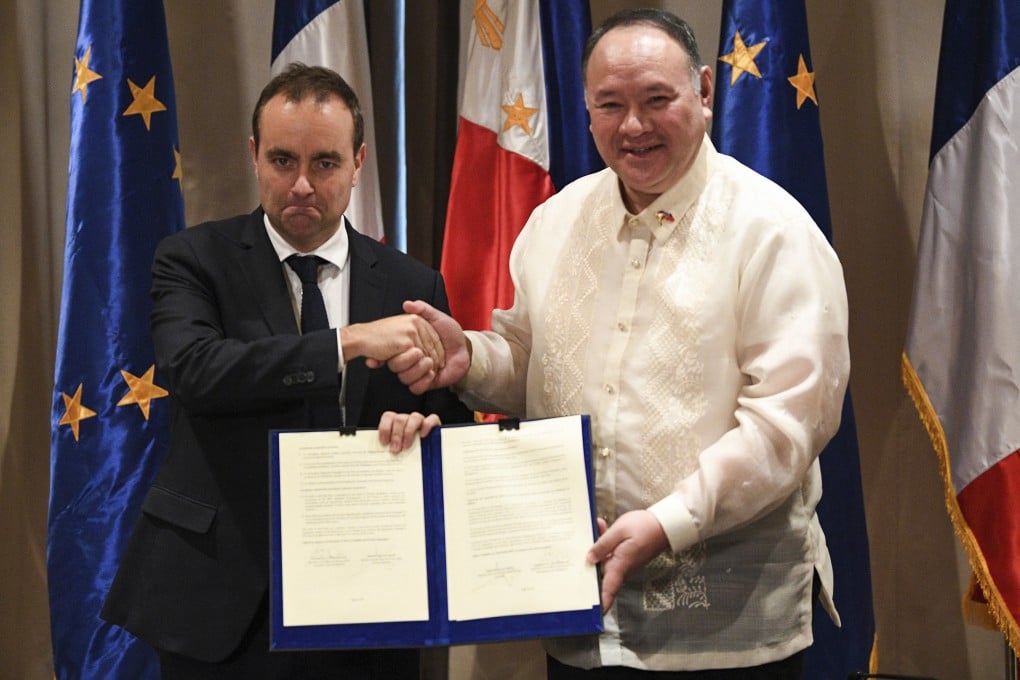 France’s armed-forces minister Sebastien Lecornu (left) shakes hands with Philippine defence secretary Gilbert Teodoro after signing documents in Manila last month. Photo: AFP