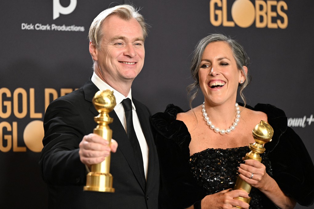 British director Christopher Nolan and his spouse, film producer Emma Thomas, pose with the Golden Globes for best director and Best motion picture - drama for “Oppenheimer” backstage at the 2024 Golden Globe Awards in Beverly Hills, California. Photo: AFP/Getty Images/TNS
