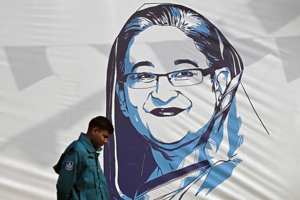 A policeman walks past a portrait of Bangladesh’s Prime Minister Sheikh Hasina, in Dhaka on Sunday. Hasina won the general election to extend her 14-year stay in office. Photo: AFP