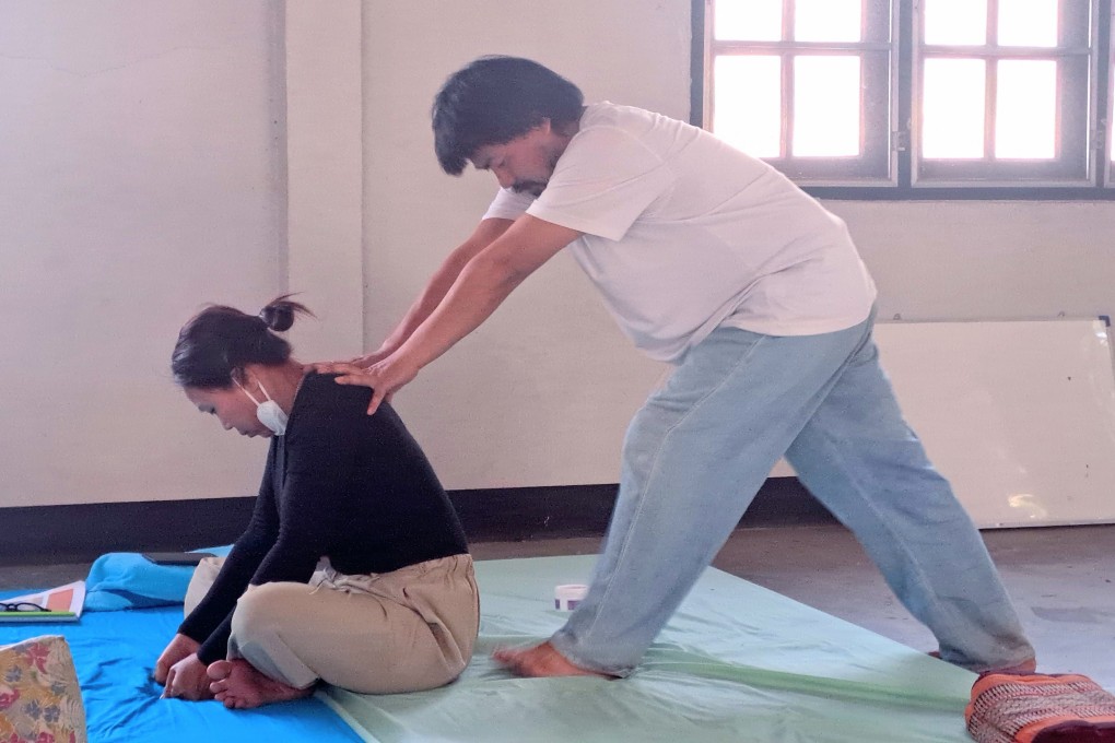 A client receives a massage at Wat Pan Whaen in Chiang Mai, Thailand. The temple’s cheap but excellent massages performed by experienced therapists attract Thais and foreigners alike. Photo: Tim Pile