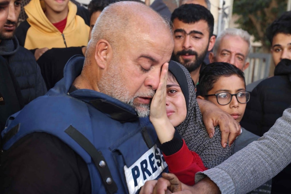 Al Jazeera’s bureau chief in Gaza, Wael Dahdouh hugs his daughter during the funeral of his son Hamza Dahdouh. Photo: AFP