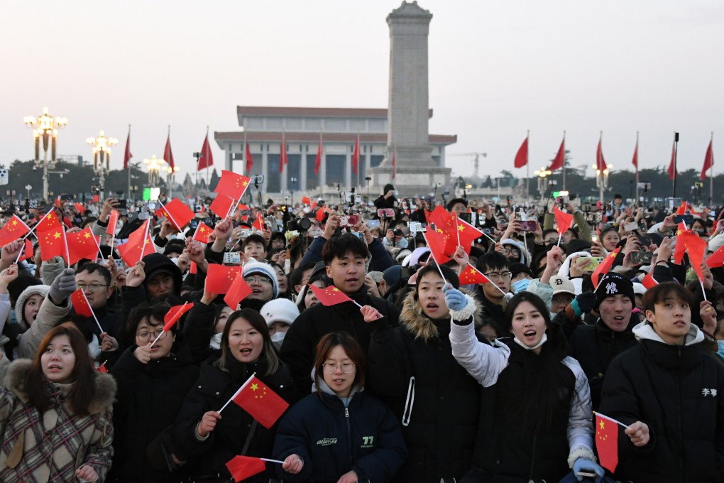 People cheer after a national-flag-raising ceremony at Tiananmen Square in Beijing on January 1. To realise its dream of national rejuvenation, China must do more to protect property rights and honour social contracts. Photo: Xinhua