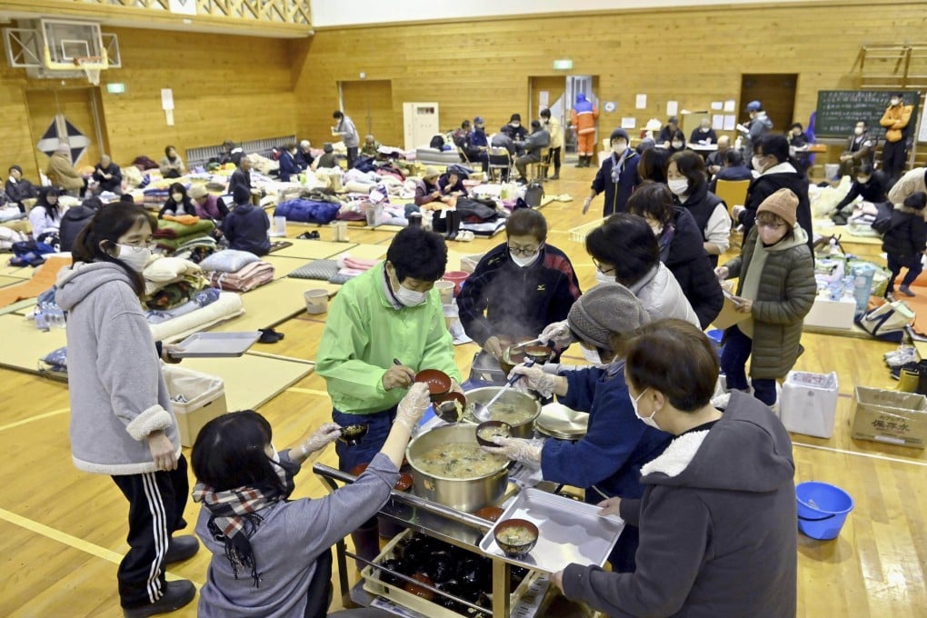Residents of a quake-hit area wait for food distribution at a shelter in Anamizu, Ishikawa prefecture on Sunday. More than 160 Japanese lost their lives in the earthquake that struck on New Year’s Day. Photo: Kyodo News via AP