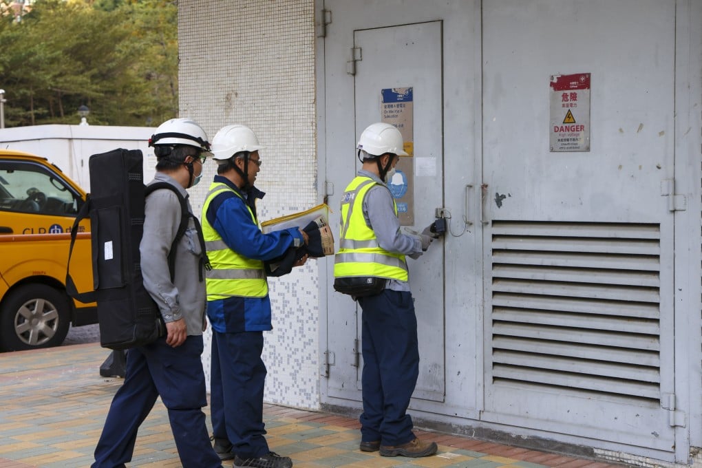 CLP engineering personnel enter a transformer electrical room during a power outage at On Mei House Building in Cheung On Estate in Tsing Yi on Sunday. Photo: Dickson Lee