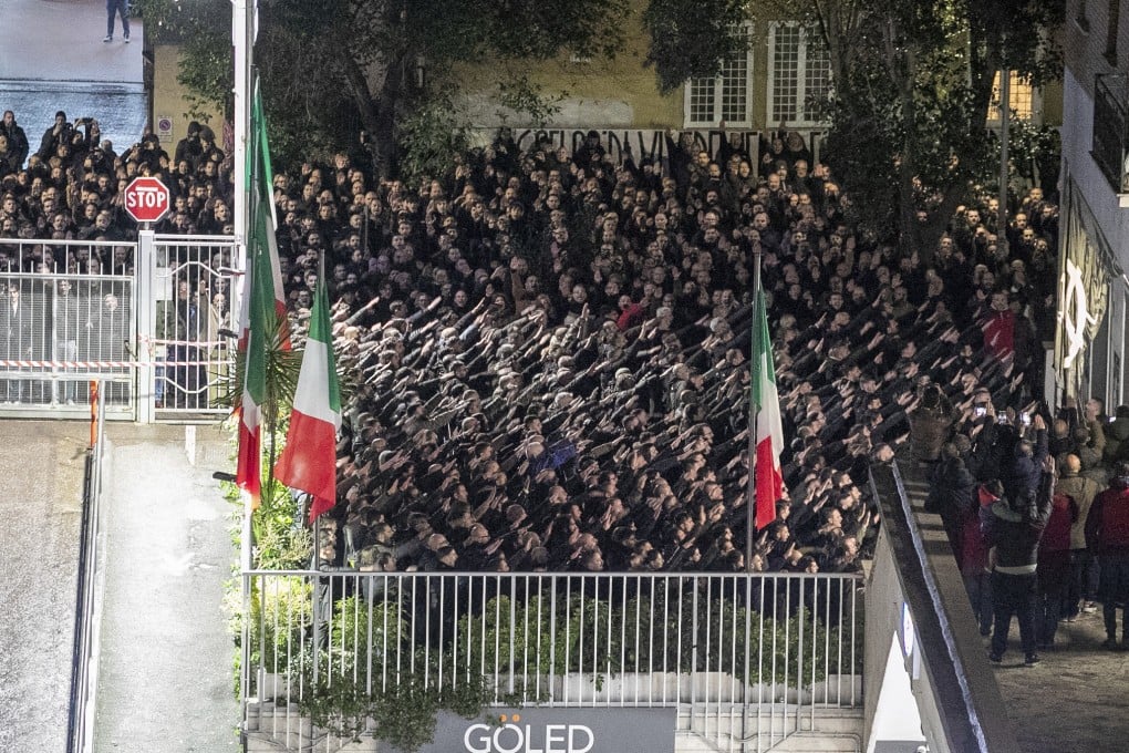 People give the banned fascist salute during a rally in Rome, on Sunday. Photo: LaPresse via AP