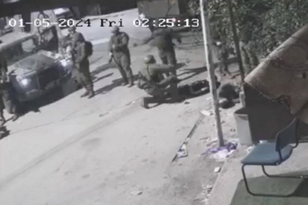 A screengrab taken from security camera footage on January 5 shows Israeli soldiers surround three men they allegedly shot, in the occupied West Bank village of Beit Rima. One, a teen, later died. Photo: UGC via AP