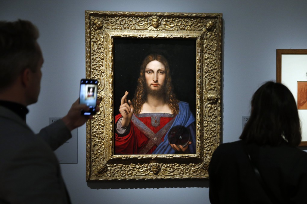 Visitors look at “Salvator Mundi” by Leonardo da Vinci at the Louvre museum on October 22, 2019 in Paris. France. The painting is among those that Russian billionaire Dmitry Rybolovlev claims he was defrauded over in a scheme involving auction house Sotheby’s and art broker Yves Bouvier. Photo: Getty Images