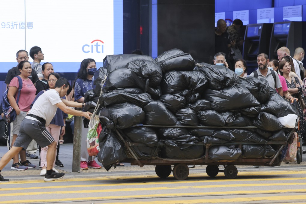 A man pushes a cart of rubbish through Central, Hong Kong, on August 17. It will take time for the community to understand the long-term benefits and importance of recycling and sustainable waste management. Photo: Jelly Tse
