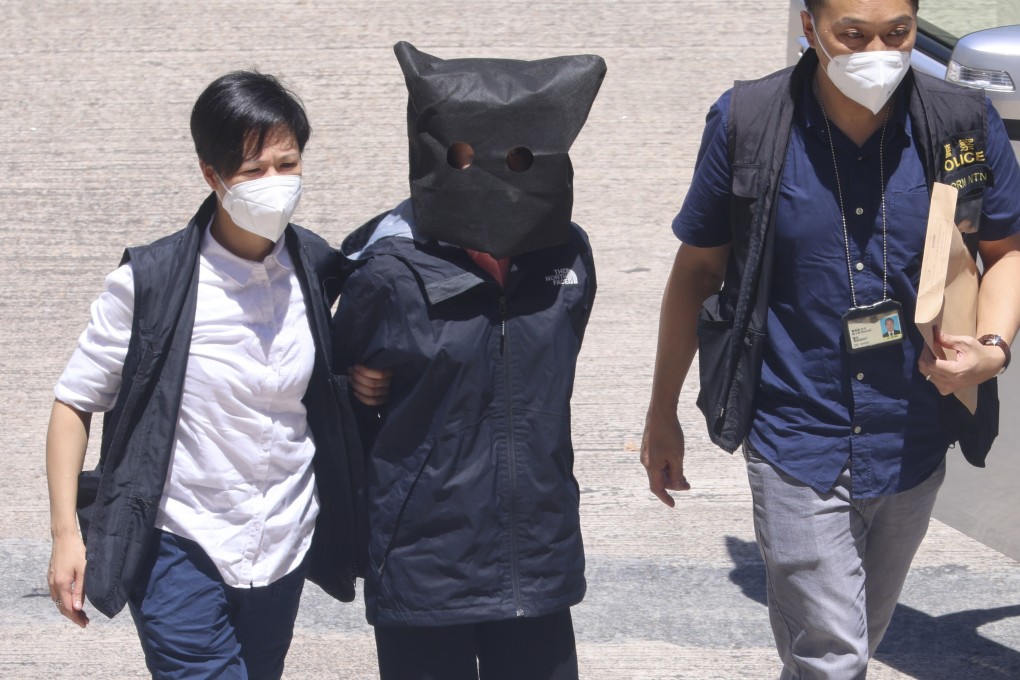 Quinn Moon (hooded) is escorted by officers to Tin Shui Wai Police Station. She is among a group of 12 Hongkongers who were arrested by mainland Chinese authorities while trying to flee to Taiwan by boat in 2020. Photo: Dickson Lee