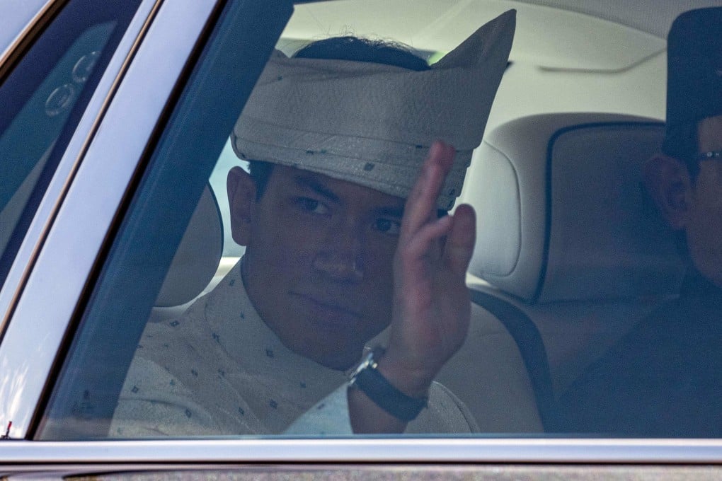 Brunei’s Prince Abdul Mateen waves from his car as he leaves following his marriage ceremony in Bandar Seri Begawan on Thursday. Photo: AFP