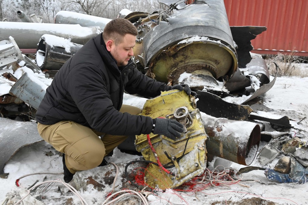 A prosecutor’s office expert inspects remains of a missile used during an attack on Kharkiv on January 2. Photo: AFP
