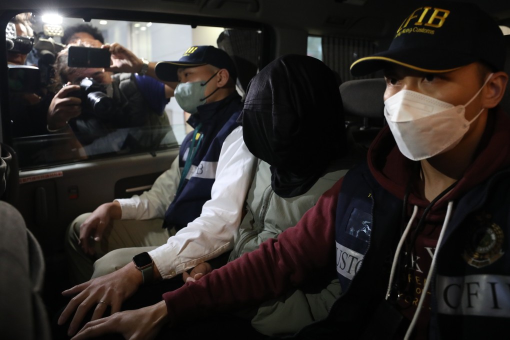 Customs officers bring in a Hong Kong man suspected of laundering HK$7.4 million. Photo: Xiaomei Chen