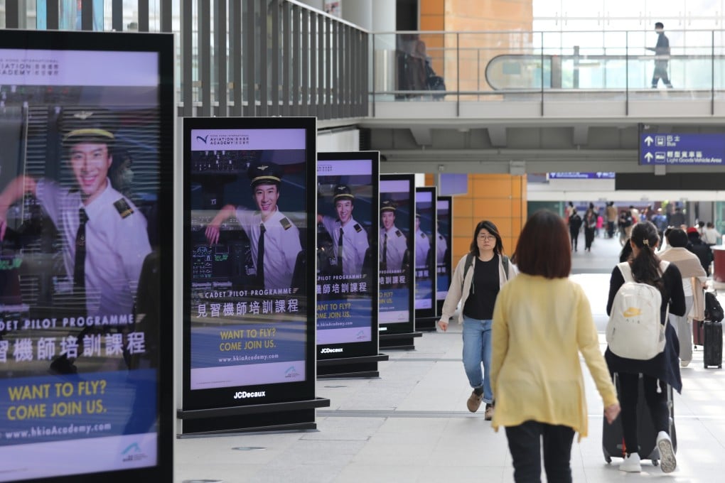 People walk past a row of pilot recruitment ads at Hong Kong International Airport on January 10. Cathay Pacific cancelled flights over Christmas and New Year because of a shortage of experienced pilots. Photo: Xiaomei Chen