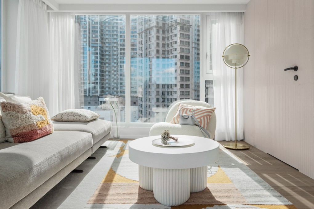 The living room of the triplex apartment in Hong Kong’s Mid-Levels designed in Nordic style by hoo. The sofa came from Poliform, the armchair and floor lamp from Gubi and the handmade Gear concrete coffee table from Norr11. Photo: hoo