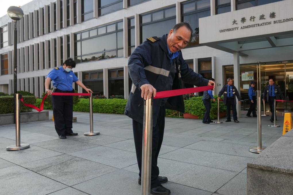 Security guards cordon off an area for reporters at the Chinese University of Hong Kong after news broke this week that Rocky Tuan was quitting as president. Photo: Eugene Lee