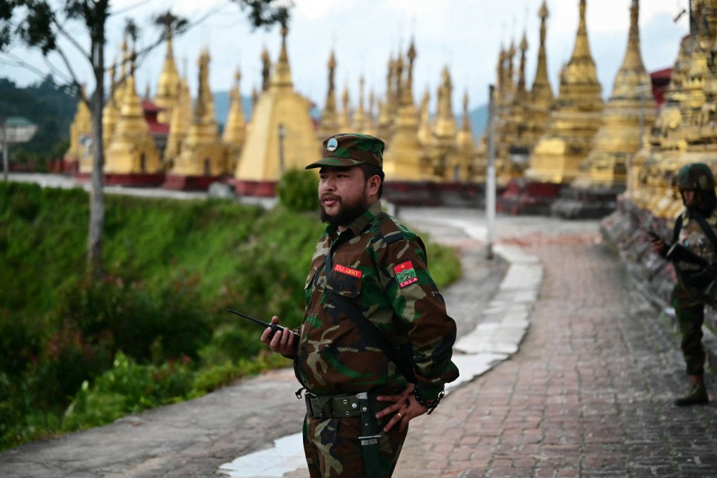 A member of the Ta’ang National Liberation Army rebel group stands guard in a temple area of a hill camp seized from the Myanmar military in northern Shan state.   Photo: AFP