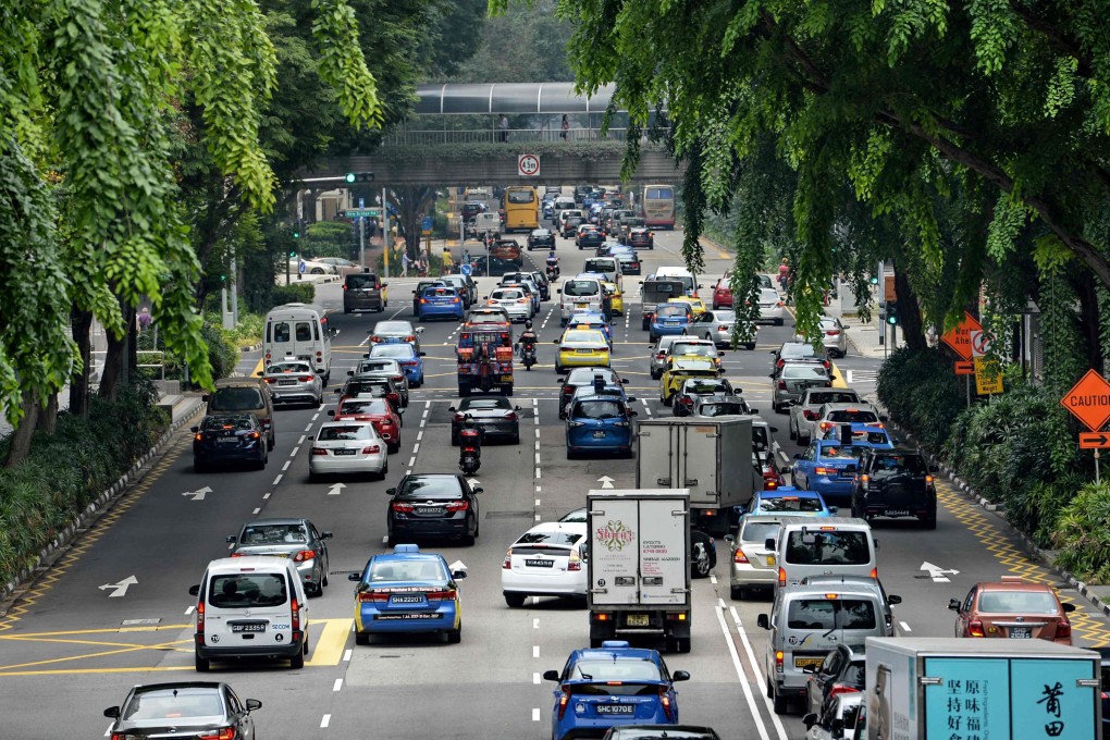 Motorists enter the financial district area in Singapore. The existing COE system has added fuel to “the sense of inequity in some quarters” of society and narratives of costs of living outpacing wage increases, says one political observer. Photo: AFP