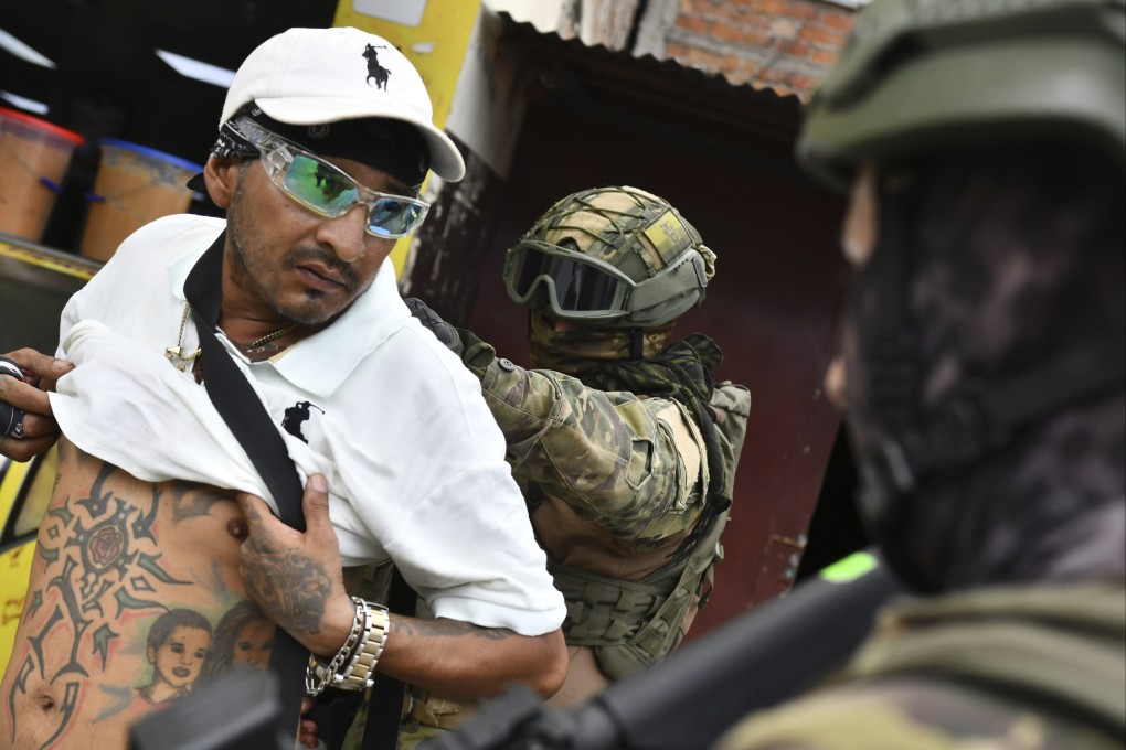 A soldier checks a man for gang tattoos during an  operation in Portoviejo, Ecuador. Photo: AP