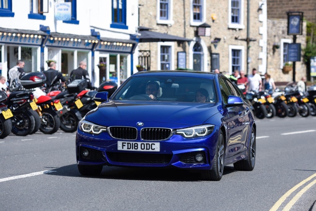 A BMW on a UK road. Drivers of these cars and another German marque, Audi, are the worst violators of speed limits, in the writer’s opinion, and potholes also contribute to make driving in Britain a misery at times. Photo: Shutterstock