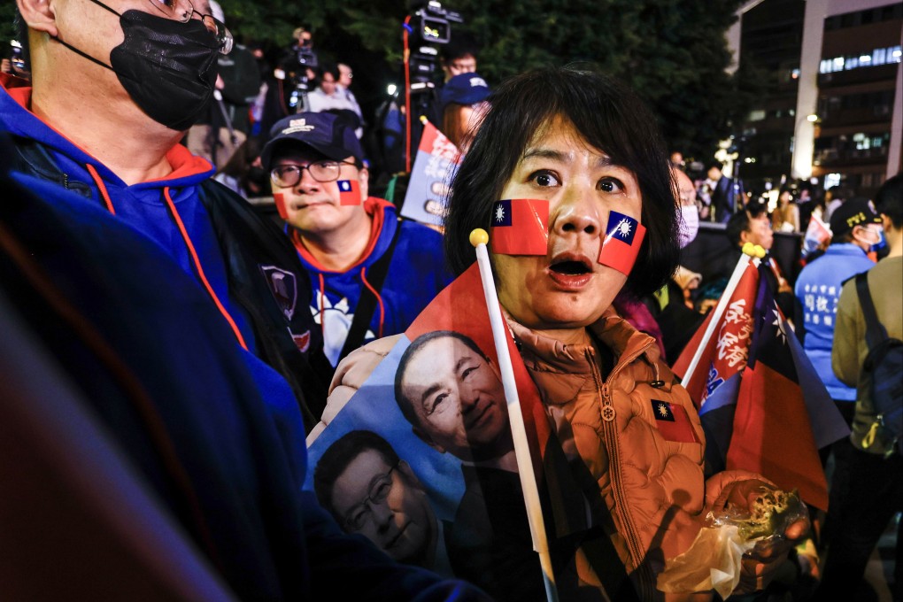 A supporter of the Beijing-friendly Kuomintang (KMT), or the Chinese Nationalist Party, id drrn during the party’s final campaign rally on Friday. Photo: EPA-EFE