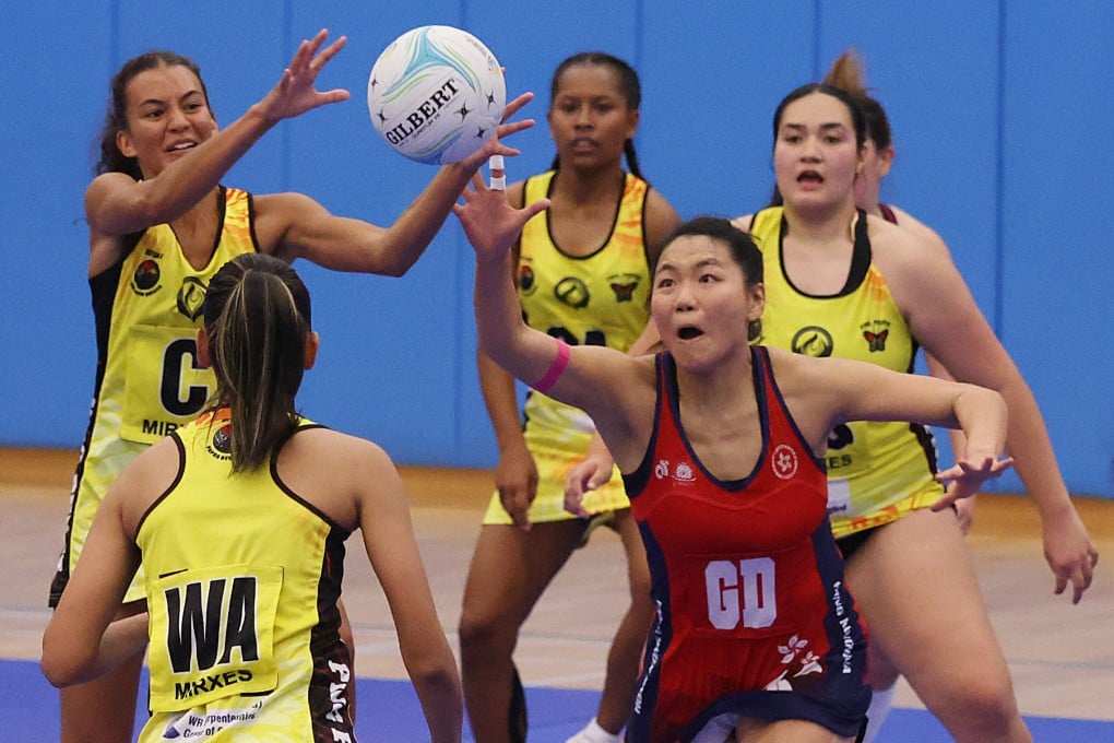 Hong Kong’s Lo Fung-yee is surrounded by Papua New Guinea players during the final at Kowloon Park Sports Centre. Photo: Yik Yeung-man